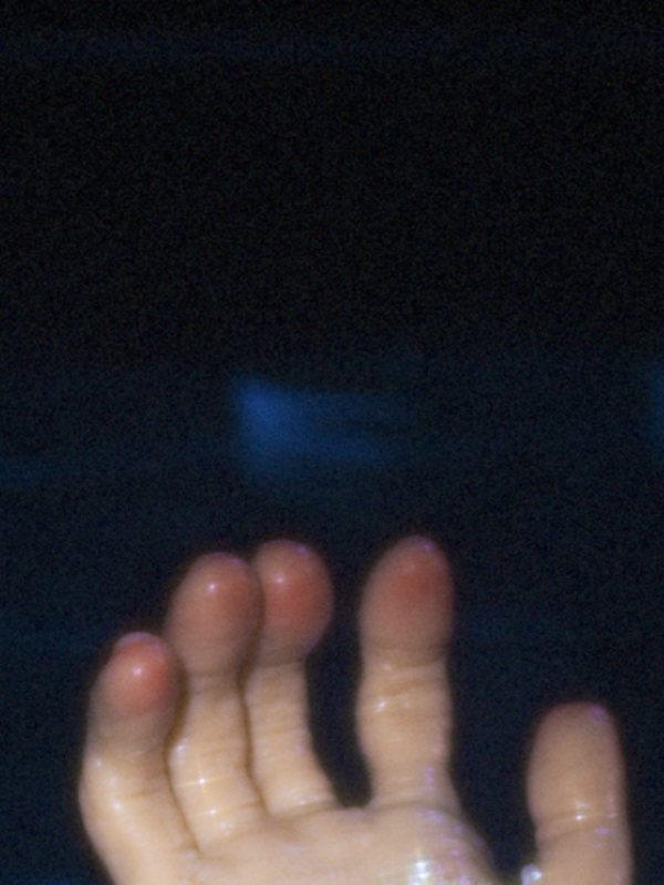 A hand under dark water
